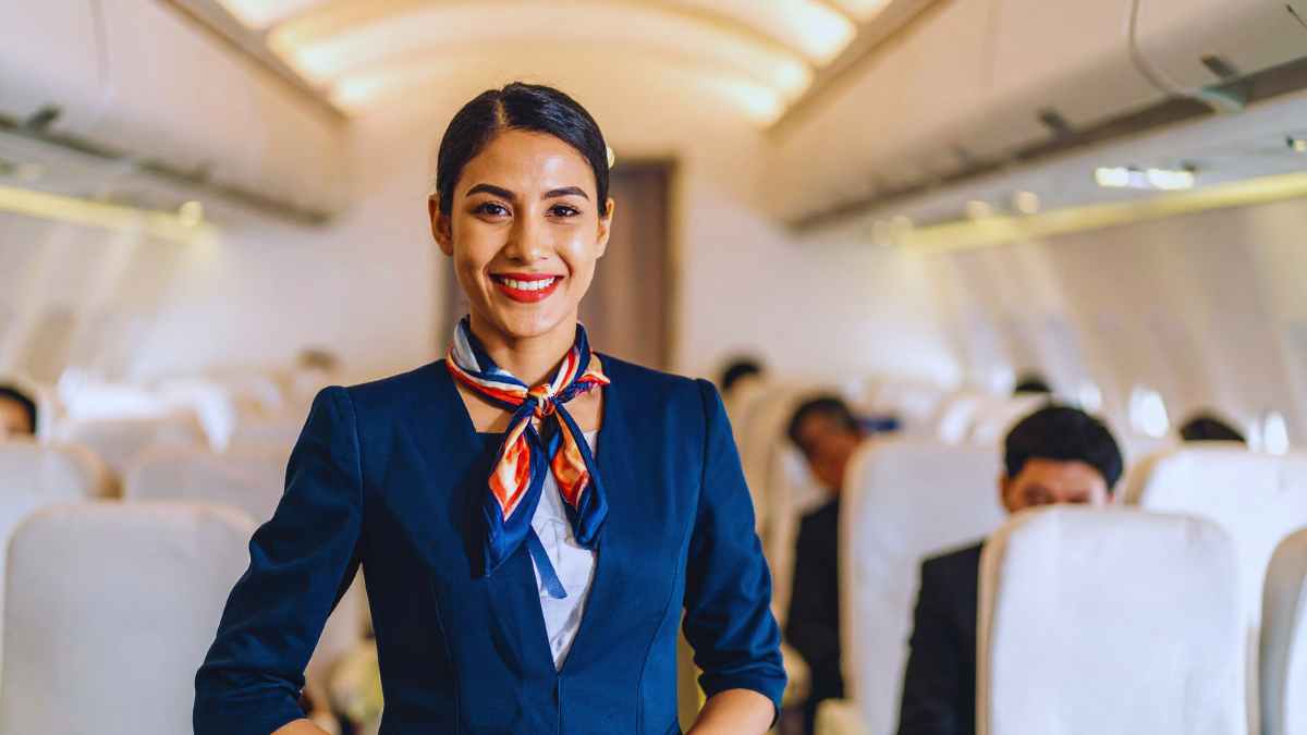 Flight attendant serving passengers in an aircraft cabin